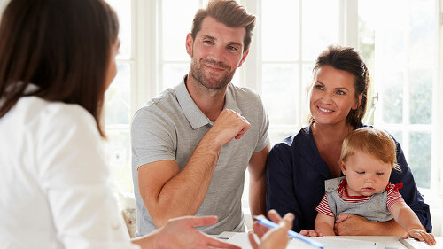 Family With Baby Meeting Financial Advisor At Home