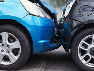 Close Up Of Two Cars Damaged In Road Traffic Accident