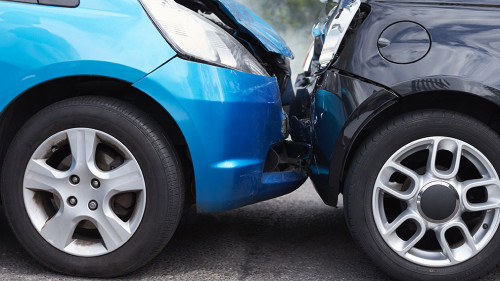 Close Up Of Two Cars Damaged In Road Traffic Accident