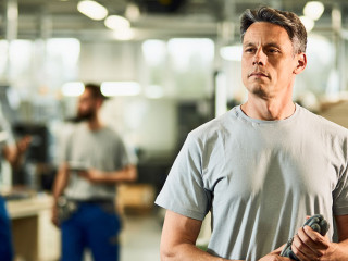 Portrait of industrial facility engineer at production line.