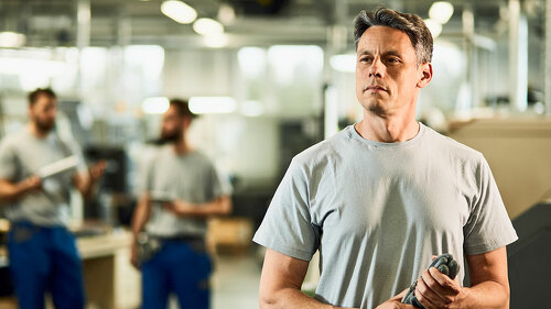 Portrait of industrial facility engineer at production line.
