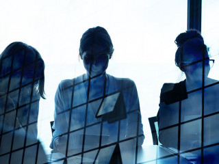 Silhouette of businessperson in office with skyscraper effect. concept of partnership and teamwork