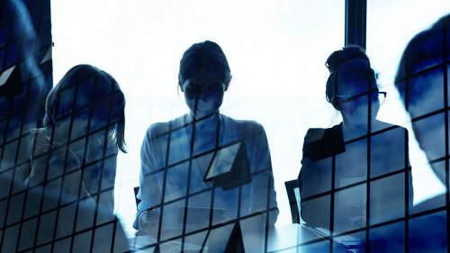 Silhouette of businessperson in office with skyscraper effect. concept of partnership and teamwork