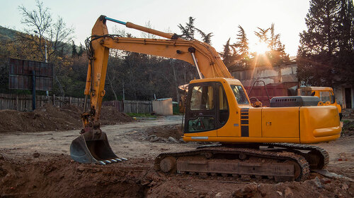 industrial machinery is working on sunset