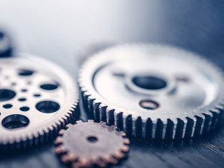 Different shapes cogwheels ling on the black background.
