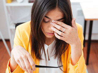 Tired businesswoman sitting at her workplace