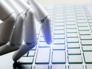 Robot hand pressing computer keyboard enter