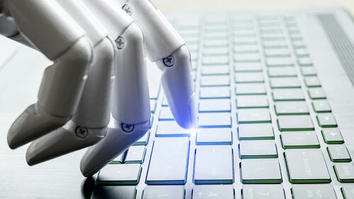 Robot hand pressing computer keyboard enter