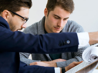 Business young man explaining terms of contract to his client in
