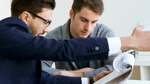 Business young man explaining terms of contract to his client in
