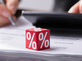 Businessperson Calculating Invoice With Calculator