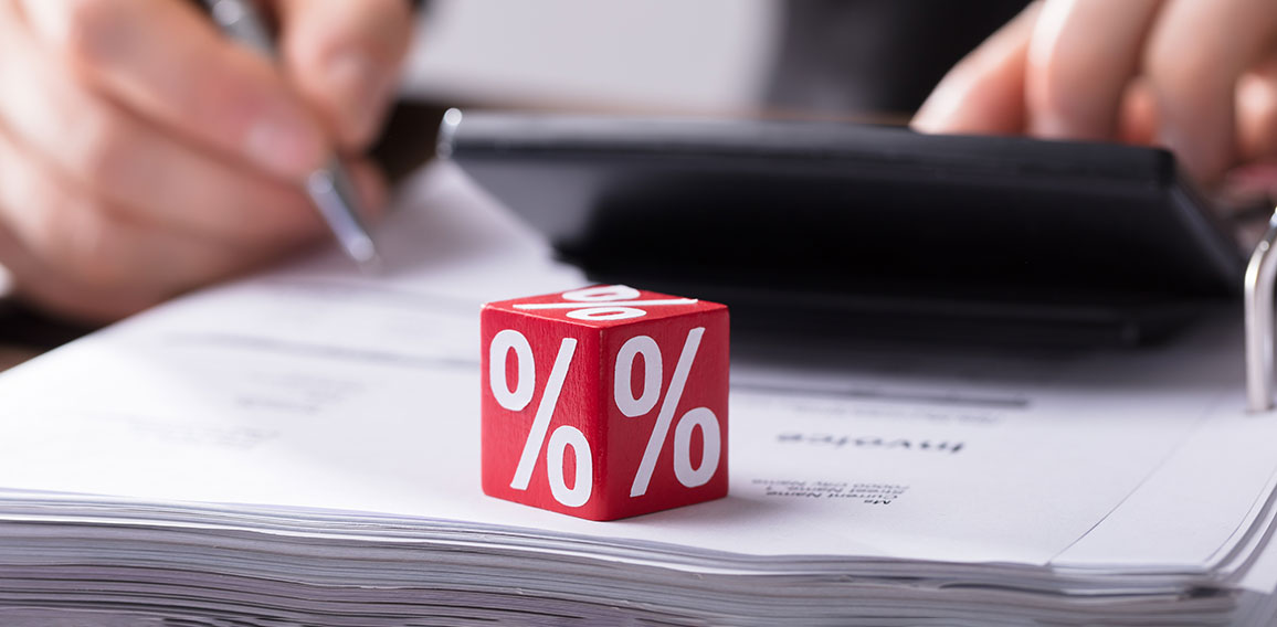 Businessperson Calculating Invoice With Calculator