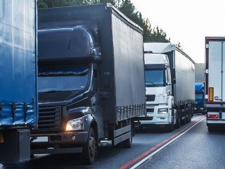 Trucks in a traffic jam on a suburban highway.