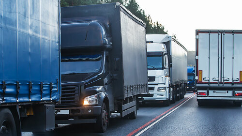 Trucks in a traffic jam on a suburban highway.
