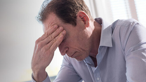Stressed businessman sitting in office