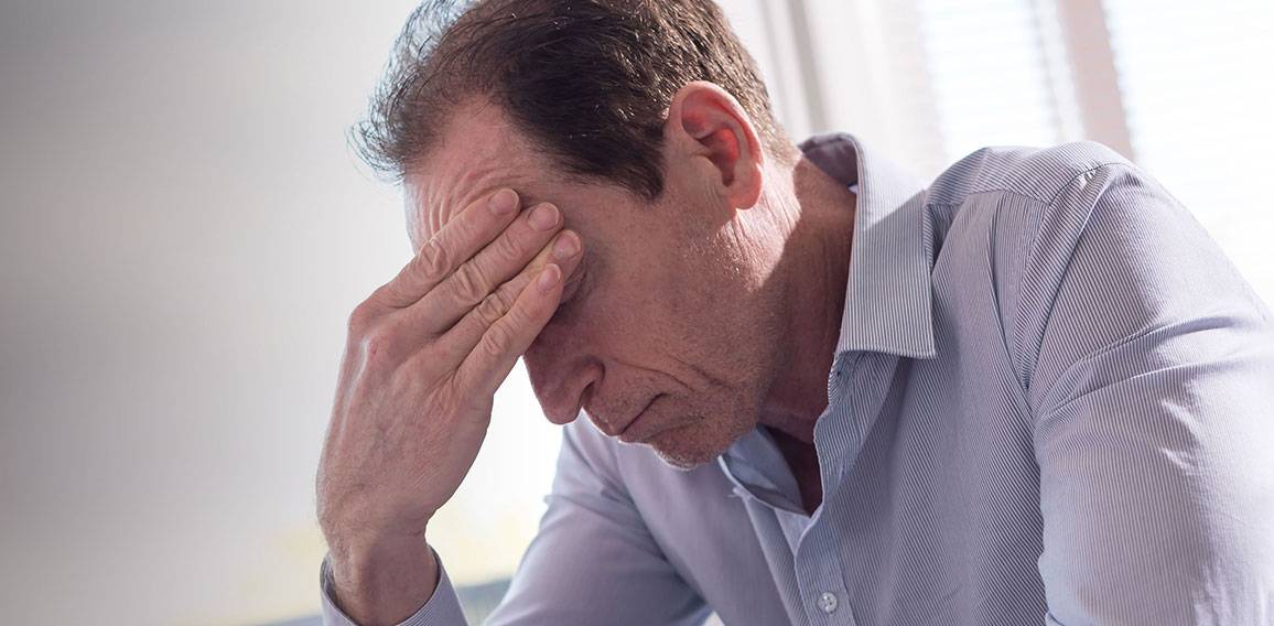 Stressed businessman sitting in office