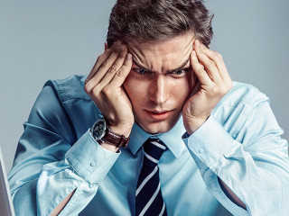Young worker sitting in his office thinking. Business concept