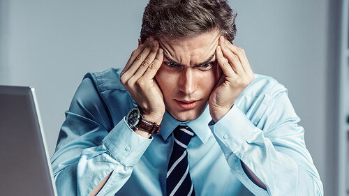 Young worker sitting in his office thinking. Business concept