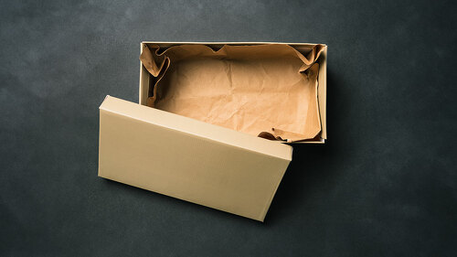 Open empty box with a lid, isolated on a black background. Cardboard box for shoes or gift. Top view, flat layout