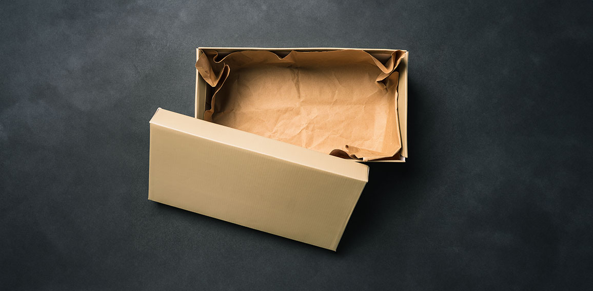 Open empty box with a lid, isolated on a black background. Cardboard box for shoes or gift. Top view, flat layout
