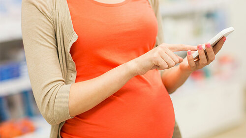 schwangere-tippt-handy-91345491-FO-Syda-Productions