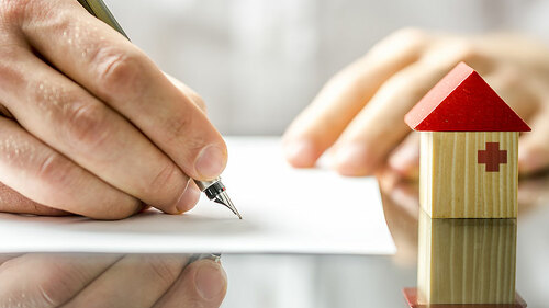 Hand-unterschreibt-Vertrag-Haeuschen-60245643-FO-Gajus