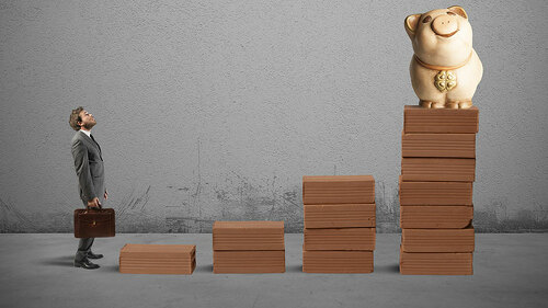 mann-vor-stufen-zum-sparschwein-75382085-FO-alphaspirit