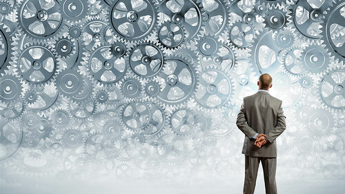 Anzugtraeger-vor-Zahnraedern-63348689-FO-Sergey-Nivens