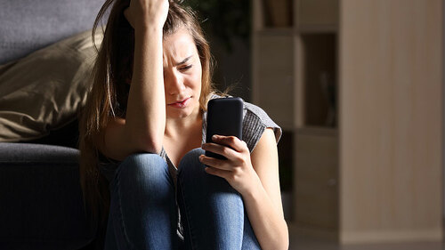 Frau-Smartphone-verzweifelt-158863543-FO-Antonioguillem